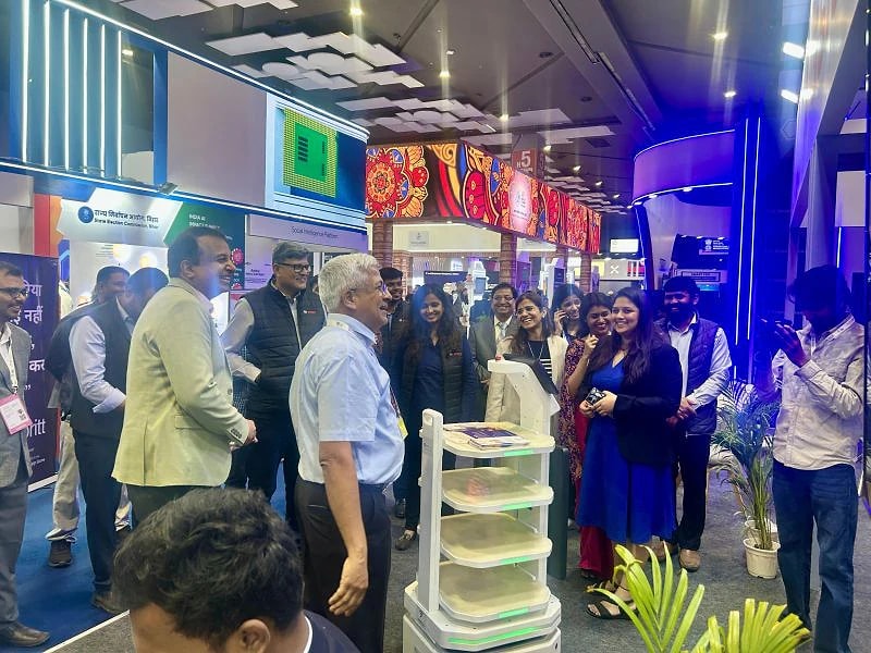 Visitors gather around an AI human on the show floor
